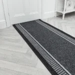 Black Greek key runner rug on a white floor