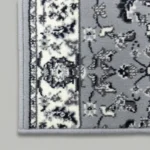 Close-up of grey and cream geometric rug pattern
