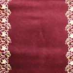 Cream floral borders on a maroon patterned rug