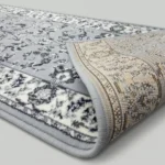Grey geometric rug showing non-slip textured backing