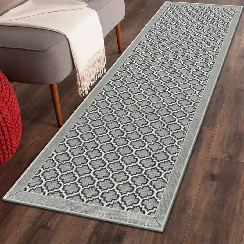 Grey quatrefoil pattern runner rug on wood floor