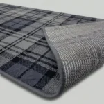 Grey tartan rug showing non-slip textured backing