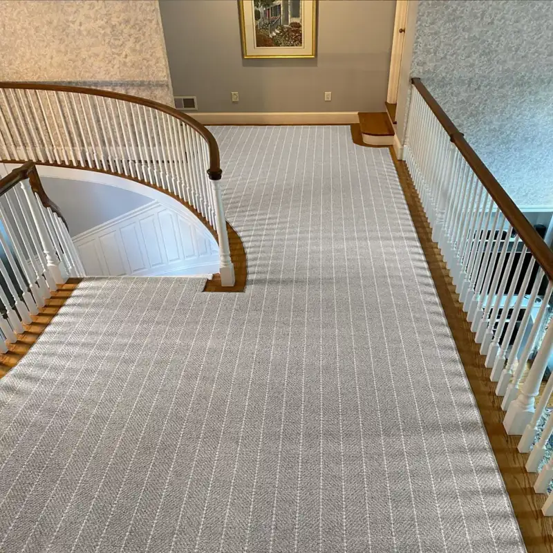Light grey striped carpet runner on a landing