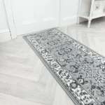 Modern grey geometric runner rug on a white floor