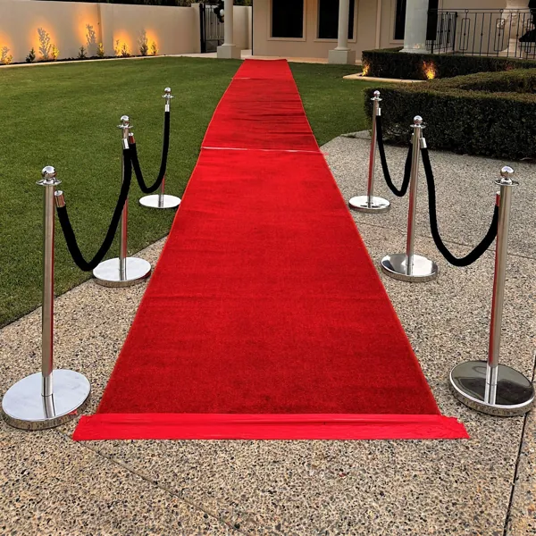 Outdoor red carpet runner with silver stanchions.