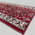 Red floral rug with white ornate border