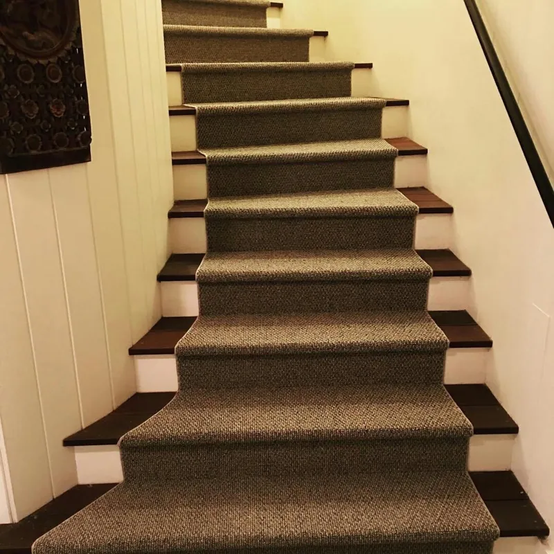 Textured grey runner on dark wood staircase