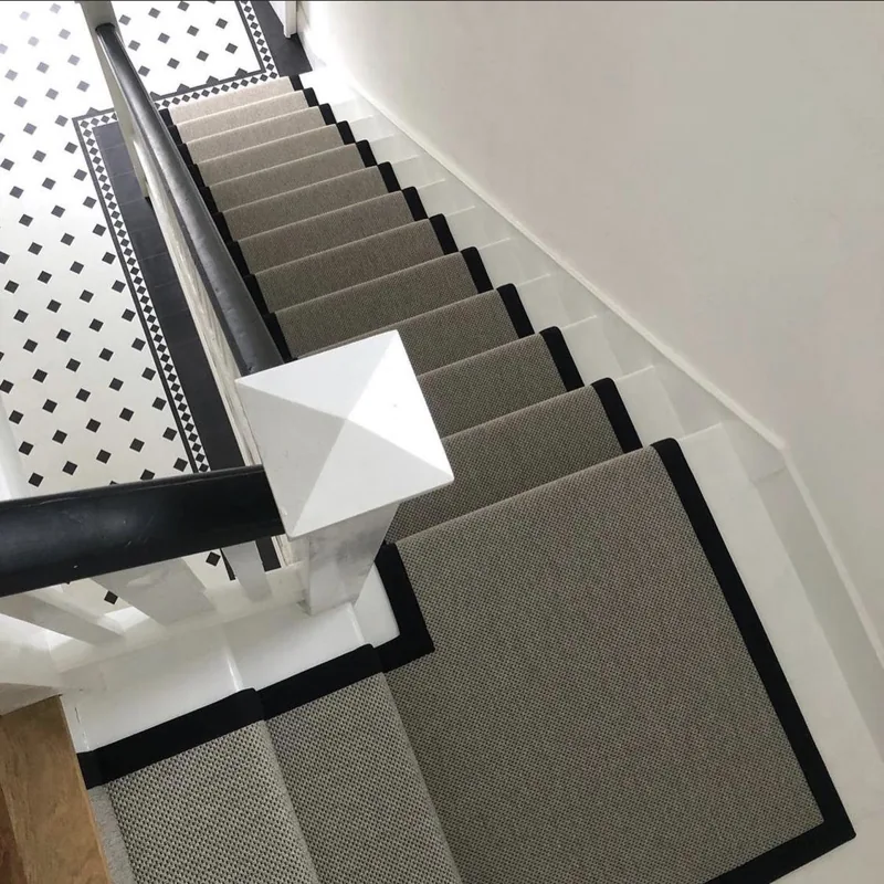 View from above of a grey runner with black borders.