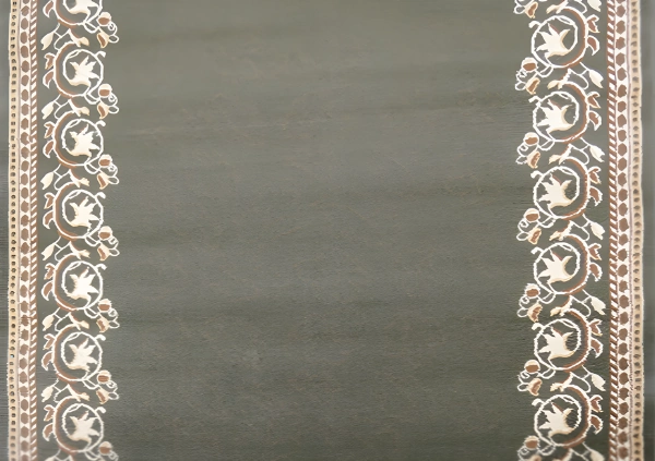 White floral scroll on dark gray background